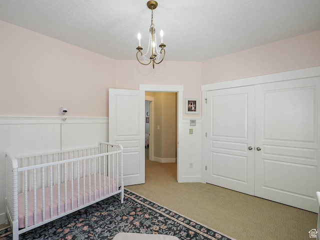 618 E Beaumont Way S, Draper, UT 84020 - carpeted bedroom featuring a chandelier, wainscoting, a closet, and a crib