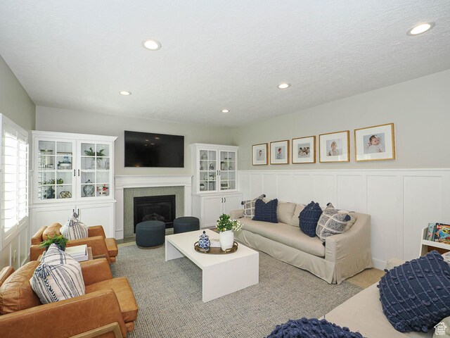 618 E Beaumont Way S, Draper, UT 84020 - living room with recessed lighting, a wainscoted wall, a glass covered fireplace, a decorative wall, and a textured ceiling