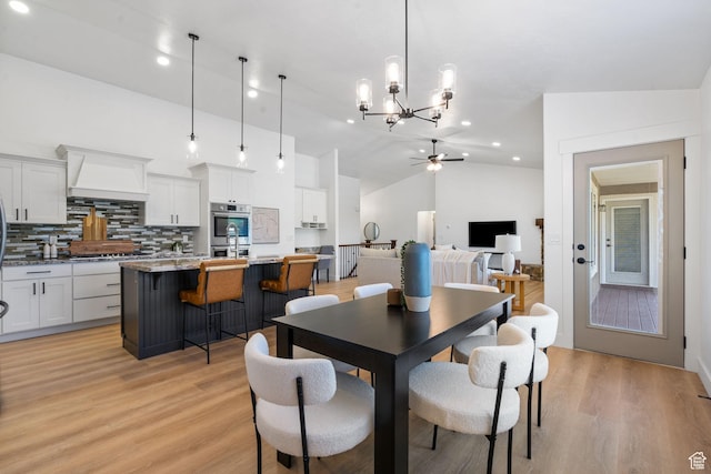 809 W 1320 N, West Bountiful, UT 84087 - dining area with a ceiling fan, light wood finished floors, vaulted ceiling, a chandelier, and recessed lighting