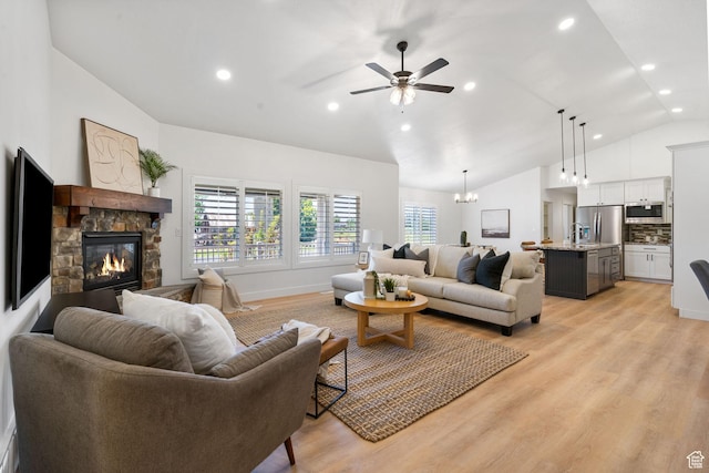 809 W 1320 N, West Bountiful, UT 84087 - living room featuring vaulted ceiling, a stone fireplace, light wood-style floors, ceiling fan, and recessed lighting