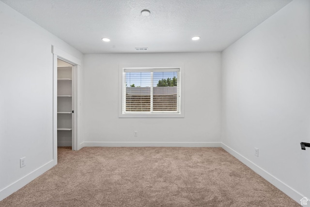 809 W 1320 N, West Bountiful, UT 84087 - unfurnished bedroom with carpet floors, a spacious closet, a textured ceiling, and recessed lighting