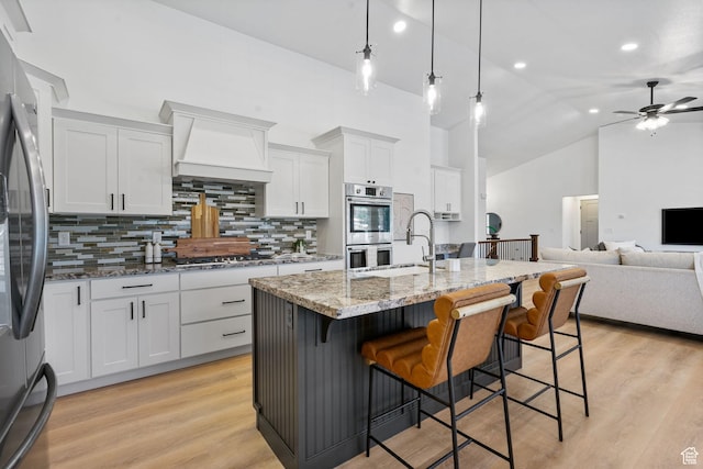 809 W 1320 N, West Bountiful, UT 84087 - kitchen with decorative backsplash, appliances with stainless steel finishes, a ceiling fan, light stone counters, and custom range hood