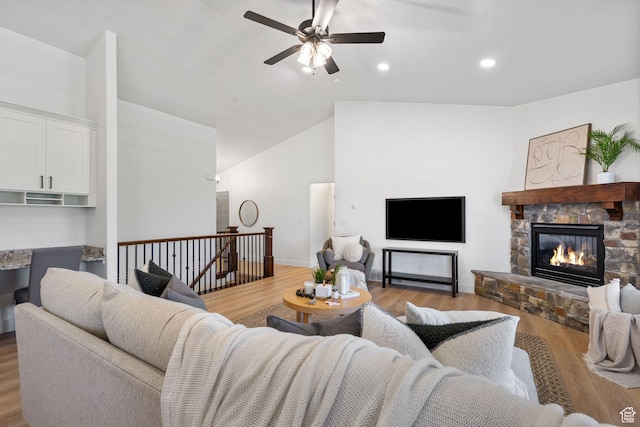 809 W 1320 N, West Bountiful, UT 84087 - living room with light wood-style floors, vaulted ceiling, ceiling fan, a stone fireplace, and recessed lighting
