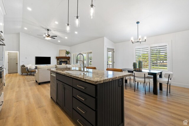809 W 1320 N, West Bountiful, UT 84087 - kitchen featuring a stone fireplace, a chandelier, recessed lighting, ceiling fan, and light wood-style flooring