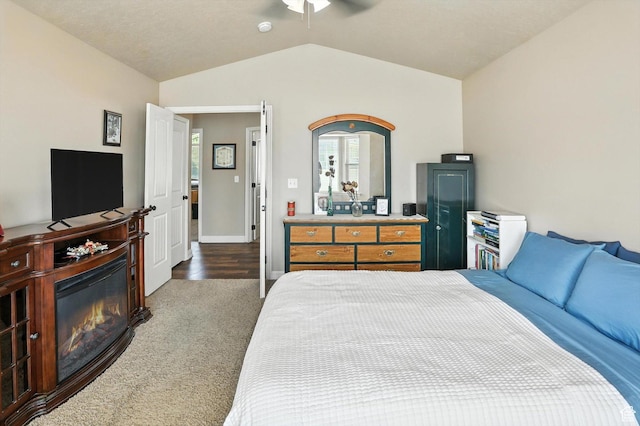 758 N 400 E, Tremonton, UT 84337 - carpeted bedroom with vaulted ceiling, a glass covered fireplace, and ceiling fan