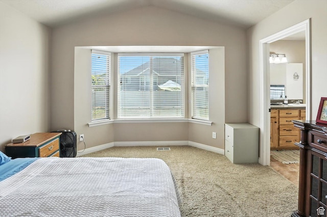 758 N 400 E, Tremonton, UT 84337 - bedroom featuring light carpet, vaulted ceiling, and ensuite bathroom