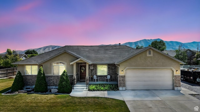 758 N 400 E, Tremonton, UT 84337 - ranch-style home with brick siding, stucco siding, a garage, concrete driveway, and a mountain view