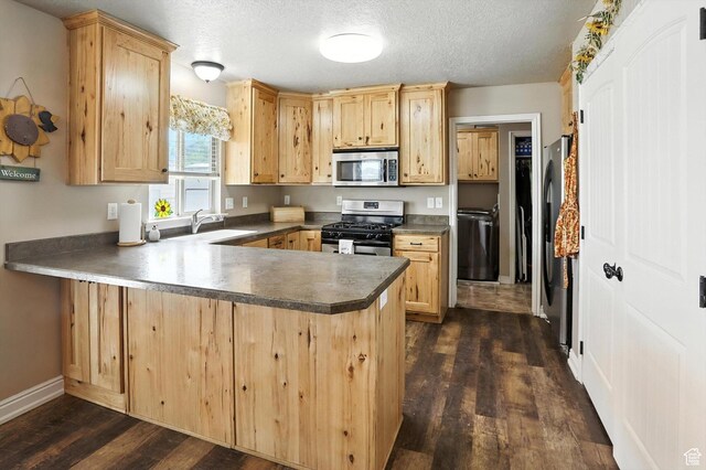 758 N 400 E, Tremonton, UT 84337 - kitchen with appliances with stainless steel finishes, a peninsula, dark wood finished floors, light brown cabinetry, and a textured ceiling