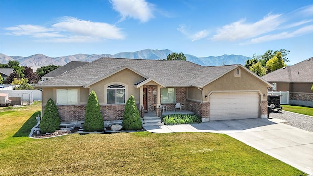 758 N 400 E, Tremonton, UT 84337 - single story home with stucco siding, a mountain view, brick siding, and a garage