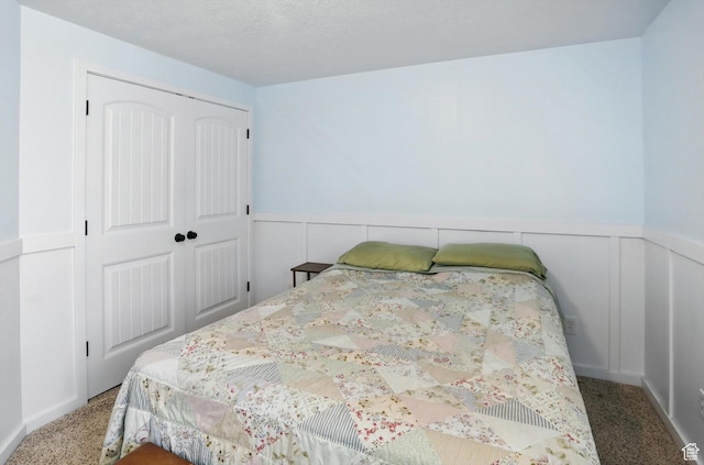 758 N 400 E, Tremonton, UT 84337 - bedroom featuring carpet floors, a wainscoted wall, and a closet