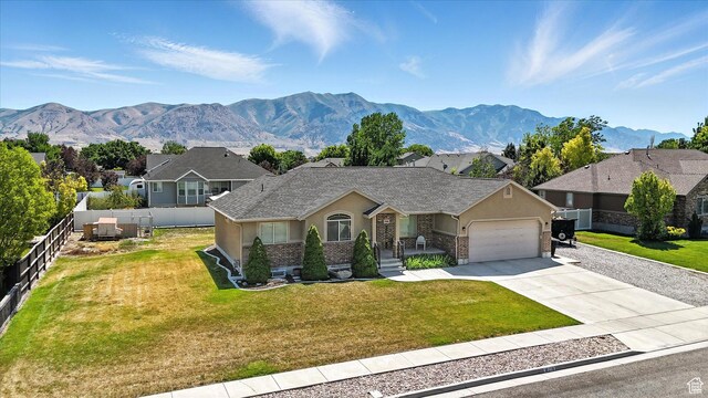 758 N 400 E, Tremonton, UT 84337 - ranch-style house with stucco siding, a garage, concrete driveway, a mountain view, and a residential view
