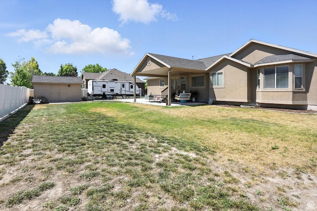 758 N 400 E, Tremonton, UT 84337 - rear view of property with stucco siding, a patio, and an outbuilding