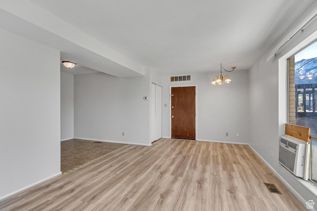 1030 Healy St Unit 2, Ogden, UT 84403 - unfurnished room featuring light wood-type flooring and a chandelier