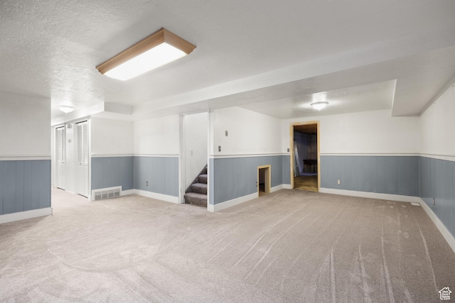 1657 E 1500 N, Logan, UT 84341 - finished below grade area with a wainscoted wall, stairs, carpet flooring, and a textured ceiling