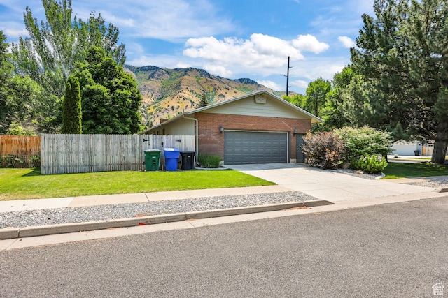 1657 E 1500 N, Logan, UT 84341 - view of front of property with brick siding, a mountain view, driveway, and a garage