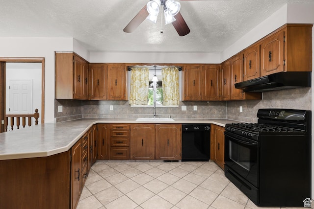 1657 E 1500 N, Logan, UT 84341 - kitchen with black appliances, under cabinet range hood, brown cabinets, and a textured ceiling
