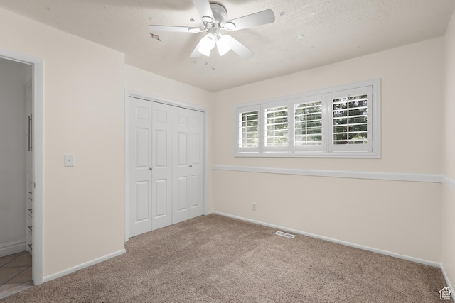 1657 E 1500 N, Logan, UT 84341 - unfurnished bedroom featuring carpet, a closet, a ceiling fan, and a textured ceiling