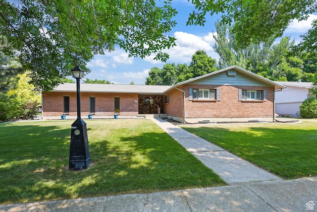 1657 E 1500 N, Logan, UT 84341 - ranch-style home featuring brick siding and a front yard