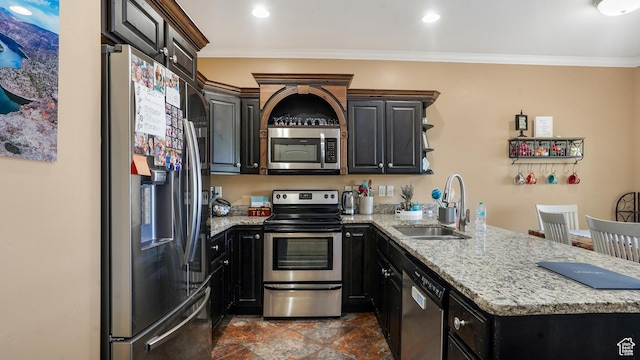 3417 S Kenna Ln Unit 1, West Haven, UT 84401 - kitchen featuring appliances with stainless steel finishes, a peninsula, ornamental molding, light stone countertops, and dark cabinets
