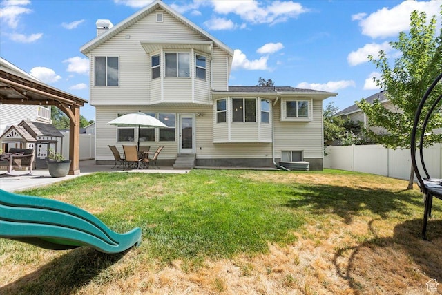 573 E Compass Cir S, North Salt Lake, UT 84054 - rear view of property featuring entry steps, a fenced backyard, a patio area, and a chimney