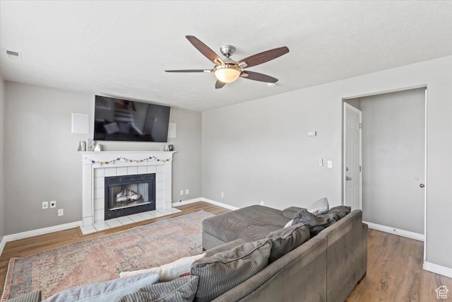 573 E Compass Cir S, North Salt Lake, UT 84054 - living area with a ceiling fan, wood finished floors, and a tile fireplace