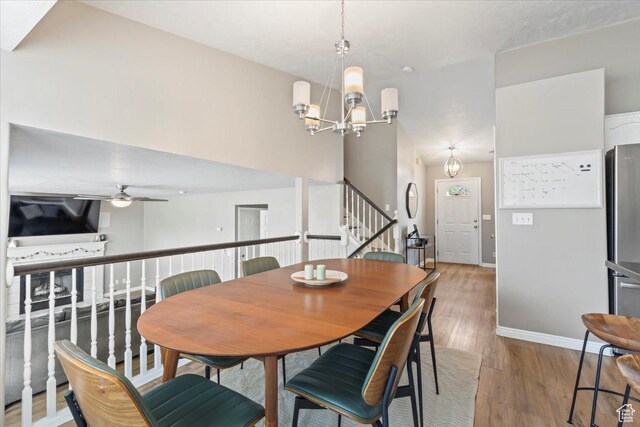573 E Compass Cir S, North Salt Lake, UT 84054 - dining room featuring stairs, light wood finished floors, a chandelier, and a ceiling fan