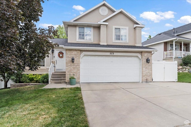 573 E Compass Cir S, North Salt Lake, UT 84054 - view of front facade featuring concrete driveway, brick siding, an attached garage, and stucco siding
