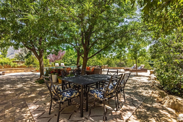 897 W Pfeifferhorn Dr, Alpine, UT 84004 - view of patio / terrace with outdoor dining space and view of wooded area