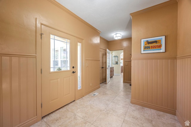 897 W Pfeifferhorn Dr, Alpine, UT 84004 - entrance foyer featuring a wainscoted wall, crown molding, light tile patterned floors, and a decorative wall