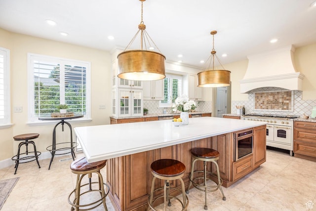 897 W Pfeifferhorn Dr, Alpine, UT 84004 - kitchen with double oven range, custom exhaust hood, light countertops, tasteful backsplash, and a spacious island