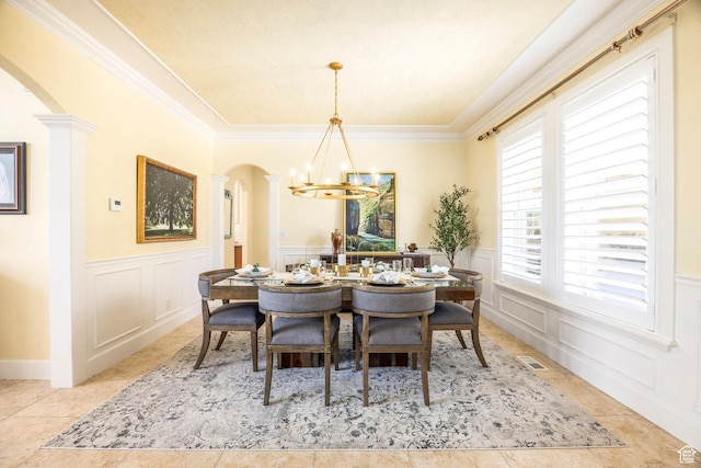 897 W Pfeifferhorn Dr, Alpine, UT 84004 - dining area featuring arched walkways, a chandelier, a decorative wall, a wainscoted wall, and crown molding