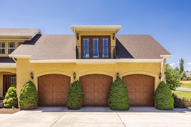 897 W Pfeifferhorn Dr, Alpine, UT 84004 - view of front of property with stucco siding, a shingled roof, a garage, and a balcony