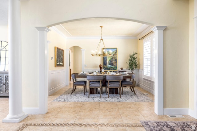 897 W Pfeifferhorn Dr, Alpine, UT 84004 - dining space featuring arched walkways, crown molding, wainscoting, a decorative wall, and tile patterned floors