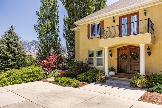 897 W Pfeifferhorn Dr, Alpine, UT 84004 - property entrance featuring a balcony, stucco siding, a mountain view, french doors, and roof with shingles