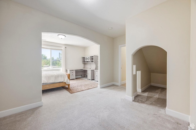 897 W Pfeifferhorn Dr, Alpine, UT 84004 - unfurnished bedroom with carpet floors, arched walkways, and lofted ceiling