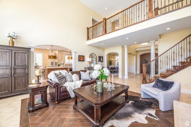 897 W Pfeifferhorn Dr, Alpine, UT 84004 - living area with ornate columns, arched walkways, a towering ceiling, and recessed lighting