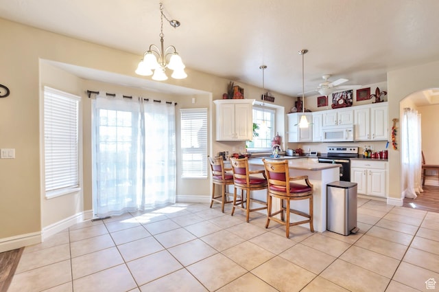 483 W 3500 N, Pleasant View, UT 84414 - kitchen featuring white microwave, electric stove, a ceiling fan, white cabinetry, and arched walkways
