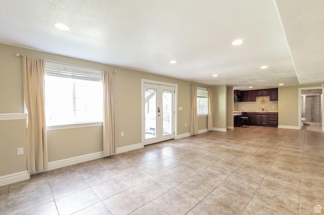 483 W 3500 N, Pleasant View, UT 84414 - unfurnished living room featuring recessed lighting, light tile patterned floors, and french doors