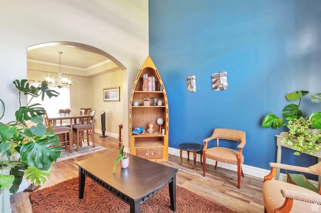 483 W 3500 N, Pleasant View, UT 84414 - living room featuring arched walkways, wood finished floors, a chandelier, and crown molding