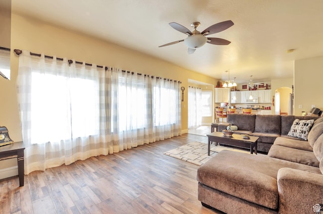 483 W 3500 N, Pleasant View, UT 84414 - living area featuring a ceiling fan, light wood finished floors, and arched walkways