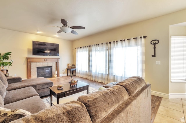 483 W 3500 N, Pleasant View, UT 84414 - living area with ceiling fan, a tiled fireplace, and light wood-type flooring