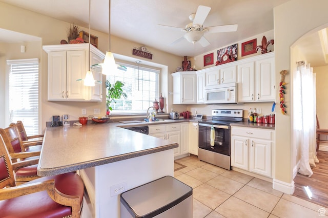 483 W 3500 N, Pleasant View, UT 84414 - kitchen featuring stainless steel electric stove, white microwave, a peninsula, and white cabinetry