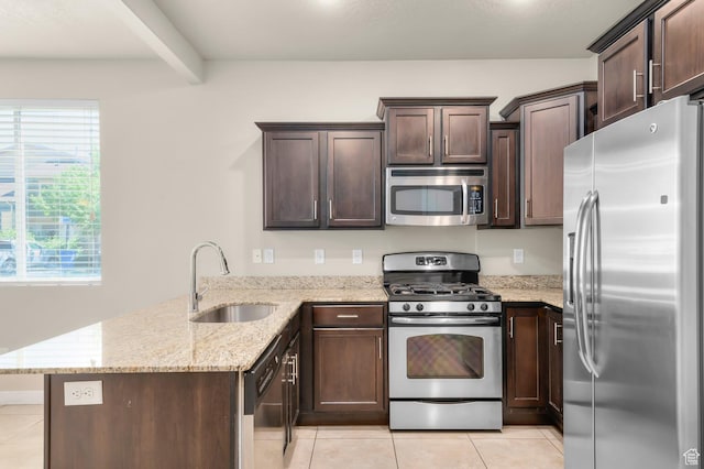 1012 W Willow Wind Dr, Farmington, UT 84025 - kitchen featuring appliances with stainless steel finishes, light tile patterned floors, a peninsula, dark brown cabinetry, and beam ceiling