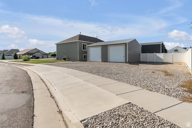 2460 N 2825 W, Plain City, UT 84404 - view of home's exterior with an outbuilding, a residential view, and a garage