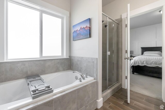 2460 N 2825 W, Plain City, UT 84404 - ensuite bathroom featuring a stall shower, a garden tub, and wood finished floors