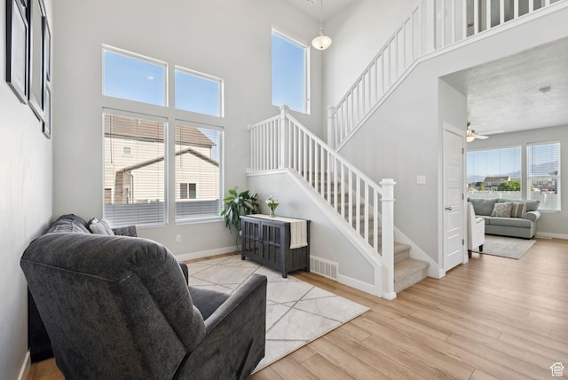 1346 W 1250 S, Springville, UT 84663 - living area with stairway, wood finished floors, ceiling fan, and a high ceiling