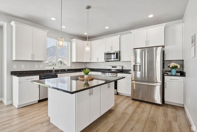 1346 W 1250 S, Springville, UT 84663 - kitchen with appliances with stainless steel finishes, light wood-style floors, white cabinets, a kitchen island, and hanging light fixtures