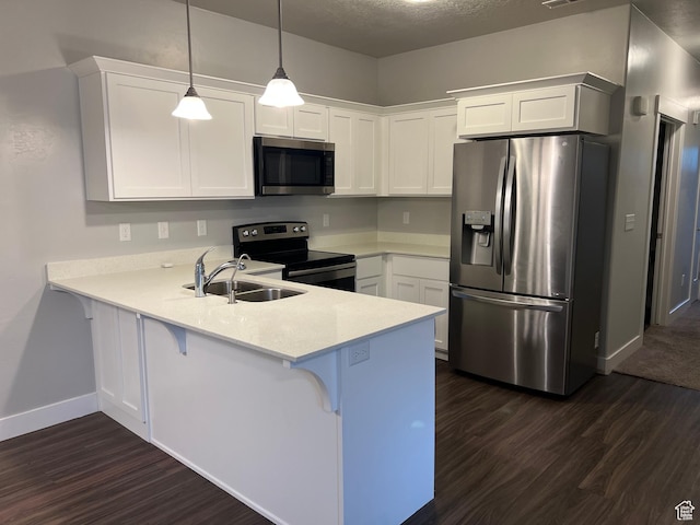 14652 S Astin Ln Unit U102, Herriman, UT 84096 - kitchen featuring appliances with stainless steel finishes, dark wood finished floors, a peninsula, light countertops, and a textured ceiling