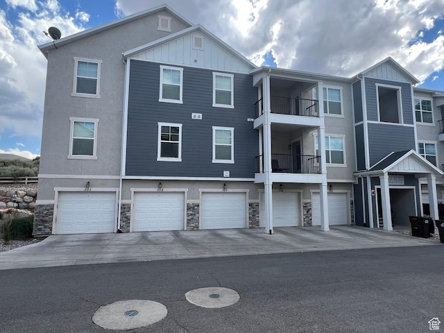 14652 S Astin Ln Unit U102, Herriman, UT 84096 - view of building exterior featuring a garage and driveway