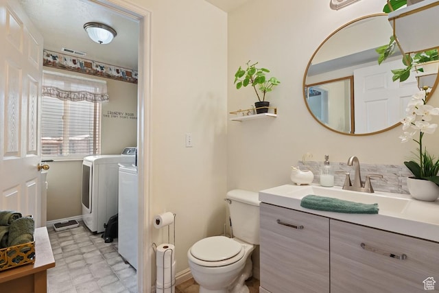 2132 W 2175 N, Clinton, UT 84015 - bathroom with tile patterned floors, vanity, and washer and dryer